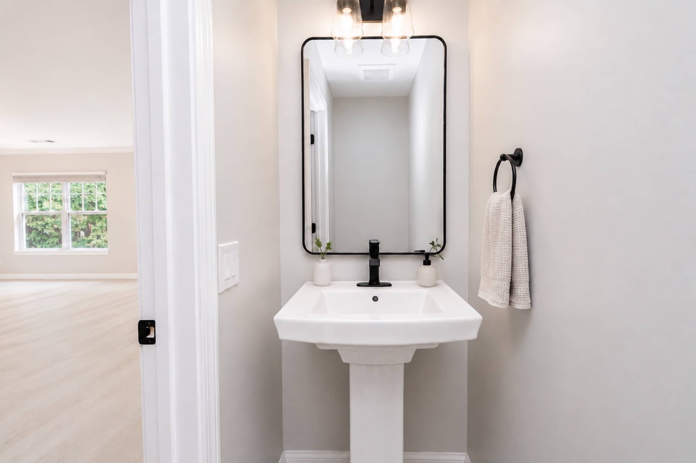 Powder room with pedestal sink at White Oaks (virtually staged)