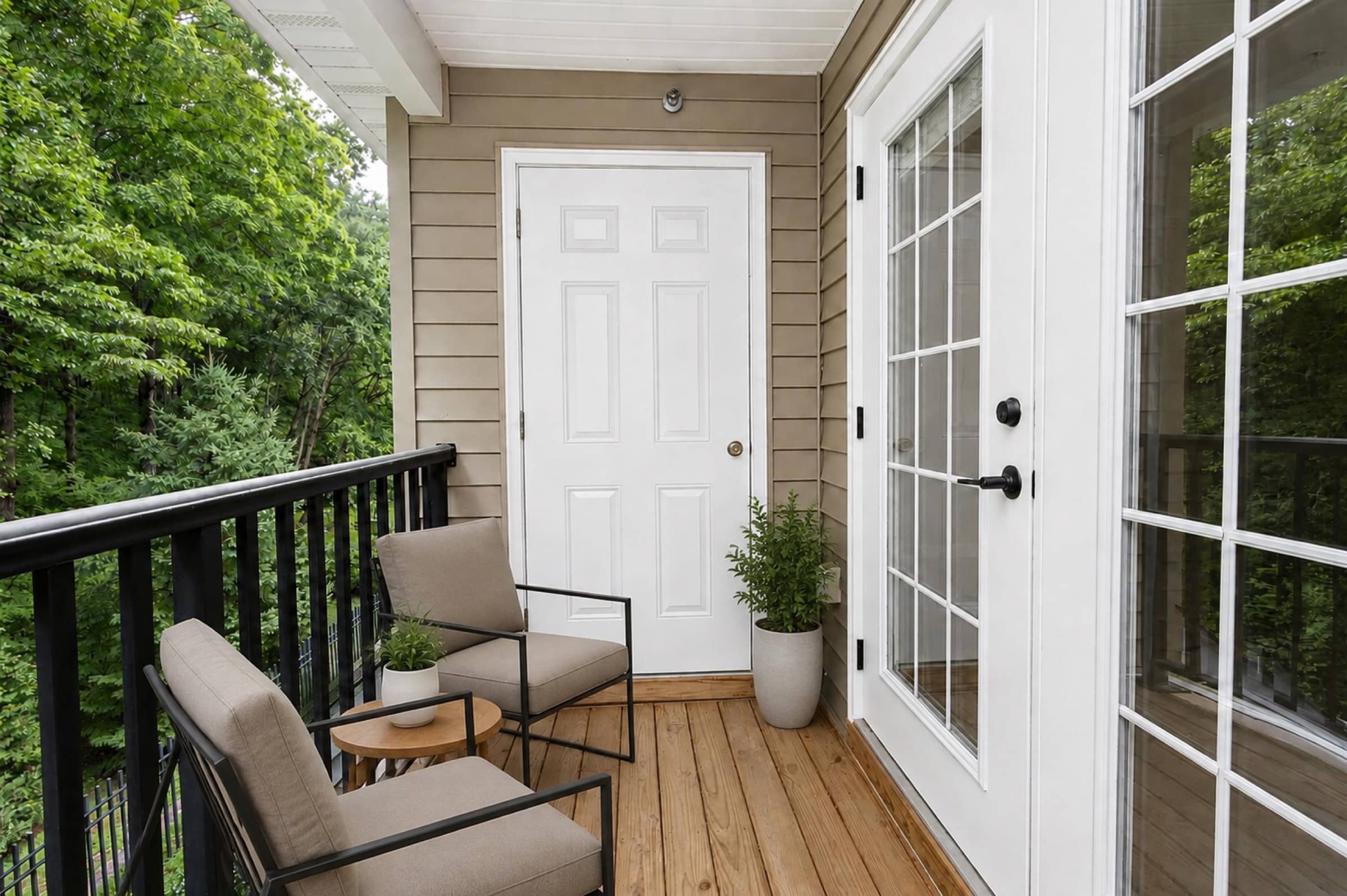 Private deck off the living room, trees beyond, at White Oaks (virtually staged)
